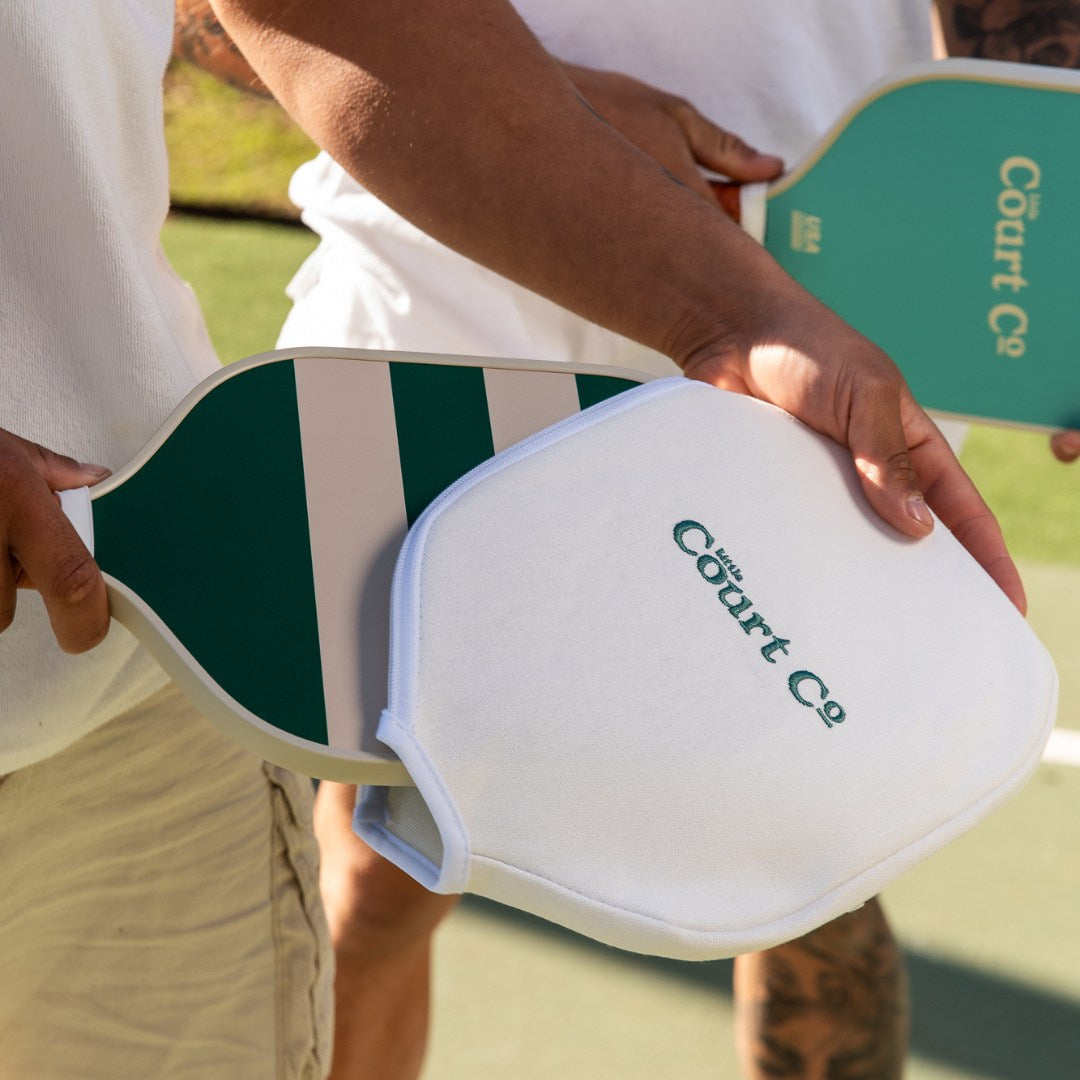 Person holding a paddle with 'Court Co' branding