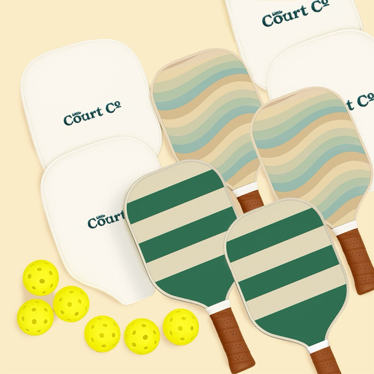 Set of pickleball paddles with striped designs and yellow balls on a beige background